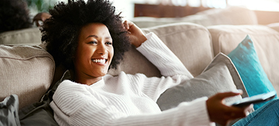 A woman watching TV with Sling