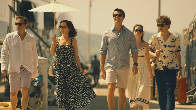 A scene with Jason Issacs, Parker Posey, Patrick Schwarzenegger, Sarah Catherine Hook, and Sam Nivola from season 3 of 'The White Lotus' on HBO and Max.