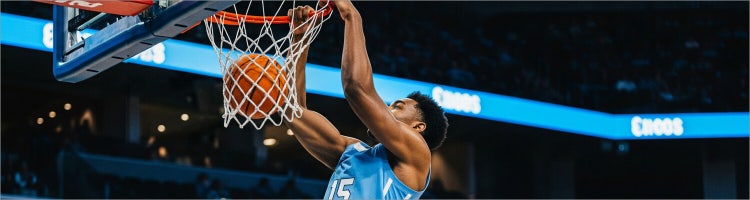 An image of a player dunking the basketball for college basketball on Sling TV.