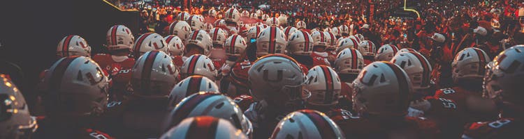 An image of University of Miami football players preparing to take the field.