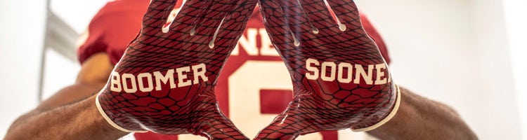 An image of an Oklahoma player with "Boomer Sooner" gloves.