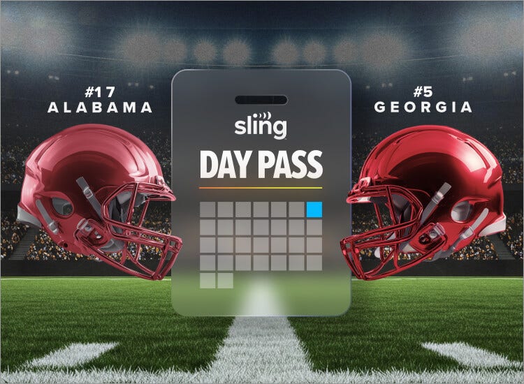 An image of a football on a tee on a grassy football field.