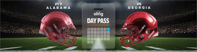 An image of a football on a tee on a grassy football field.