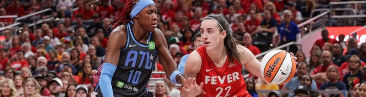 Indiana Fever star Caitlin Clark drives on Atlanta Dream defender Rhyne Howard.